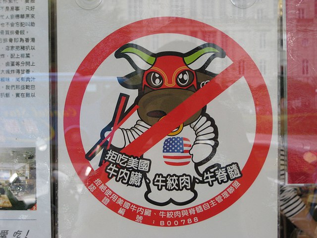 A poster reading: "No mad-cow infested beef from the US served here!"