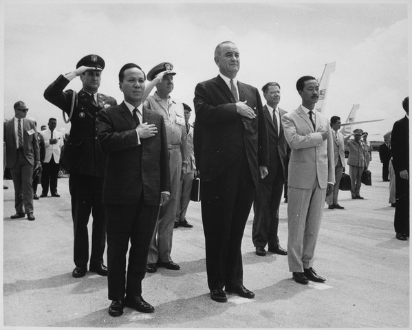 Chairman Nguyen Van Thieu, President Lyndon B. Johnson and Prime Minister Nguyen Cau Ky salute during the playing of the - NARA - Between 1960 and 1974