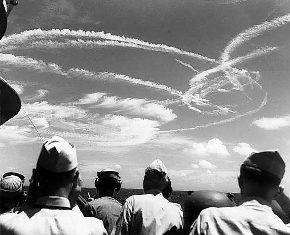 Fighter plane contrails mark the sky over Task Force 58, during the "Great Marianas Turkey Shoot" phase of the battle, 19 June 1944. Photographed from on board USS Birmingham (CL-62). (Battle of the Philippine Sea, June 1944)