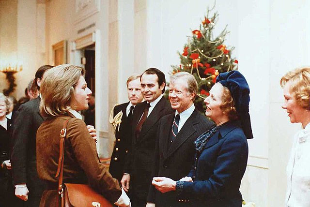 Margaret Thatcher greets her daughter, Carol, in a receiving line at the White House. President Jimmy Carter is at Thatcher's right and first lady Rosalynn Carter at her left.