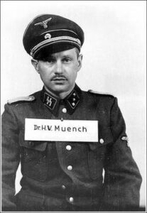 SS-Untersturmführer Hans Wilhelm Münch or Muench (14 May 1911 – c. 2001) in detention. During Operation Reinhard in World War II he served on the staff of the Auschwitz concentration camp. He was the only person acquitted of war crimes at the 1947 Auschwitz trials in Kraków. Credit: Auschwitz trials, Fair use.