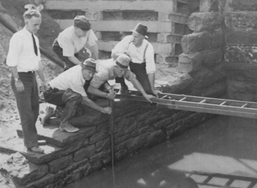 Policemen searching for human remains in a river in Kingsbury Run, Cleveland, Ohio, Sept. 1936, during the investigation about the Torso Killer crime series.