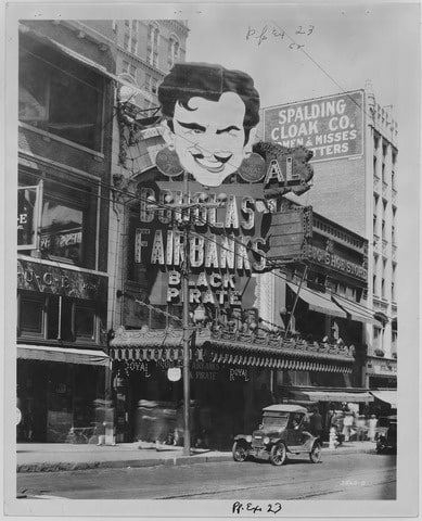 Exterior shots, both daylight and night exposures, showing the front of the theater and other businesses on the street. The marquee displays feature Clara Bow, Douglas Fairbanks, Lillian Gish, and Harold Lloyd, among others. The motion picture titles are clearly visible. #891 is a panorama of the block clearly showing details on the front of the buildings. In many of the photos cars are parked on the street.