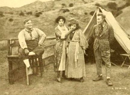 Still from the production of the American comedy film Camping Out (1919) with Roscoe Arbuckle, Alice Lake, an unidentified actress, and Al St. John, on page 234 of the January 11, 1919 Moving Picture World.