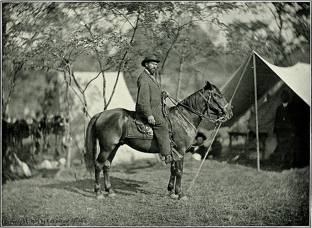 Allan Pinkerton on a horse in the middle of the Civil War. 